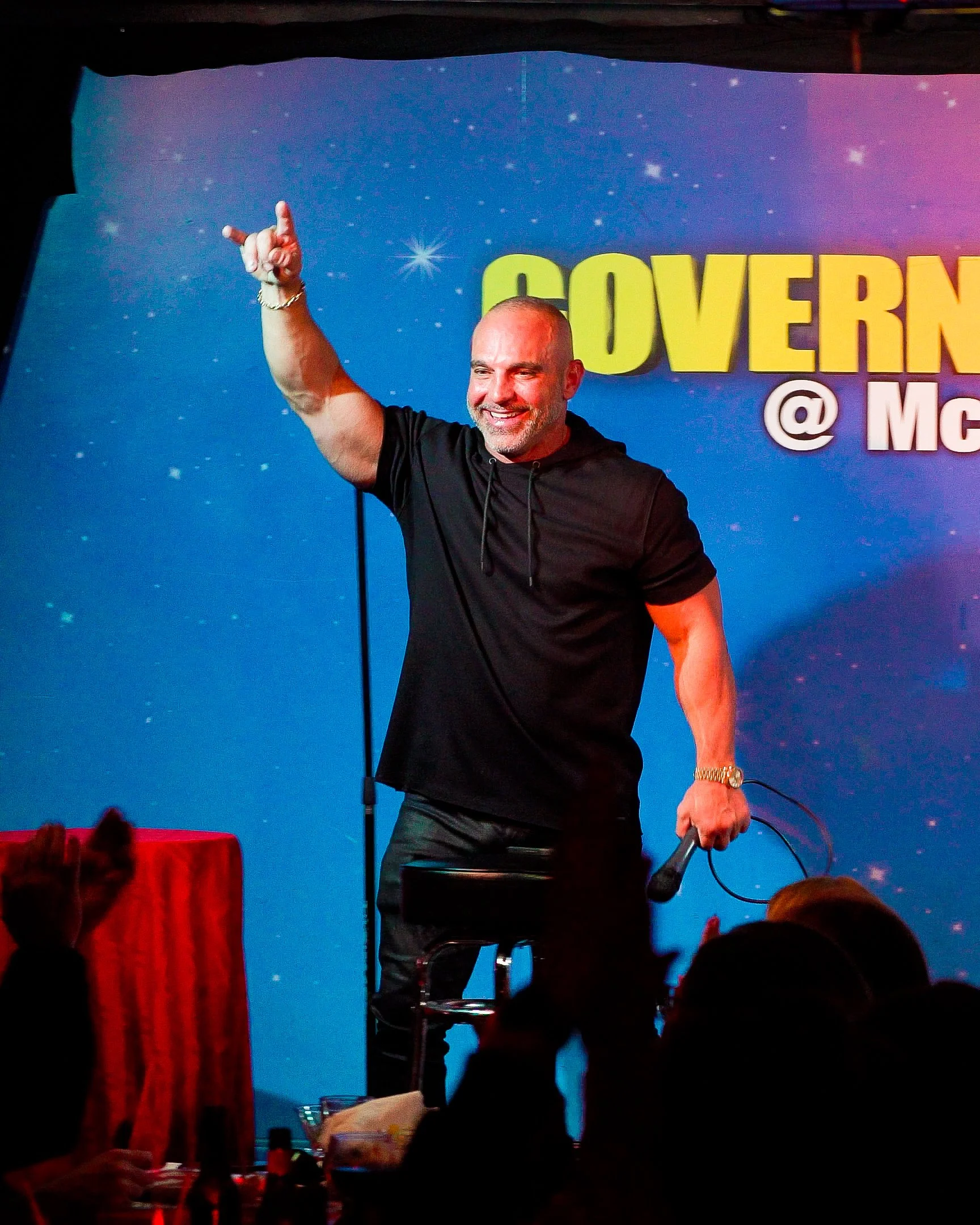 Stand-up comedian performing under theatre spotlight
