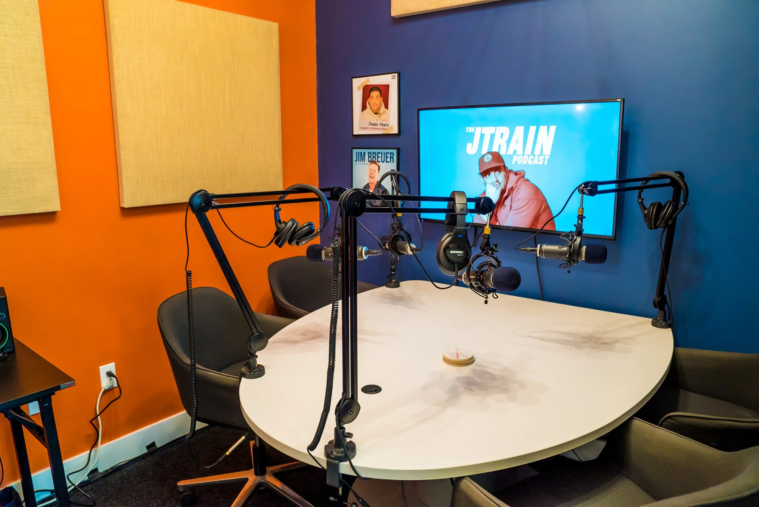 Multi-camera podcast production setup with broadcast microphones and video switchers