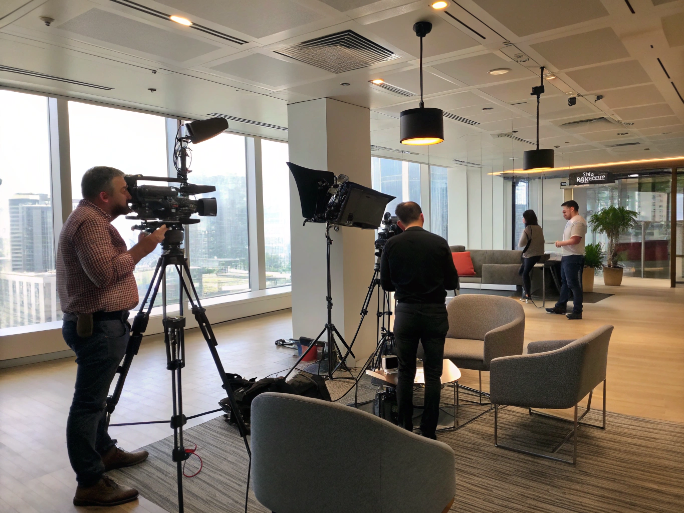 Corporate video production setup filming professional interview in modern office