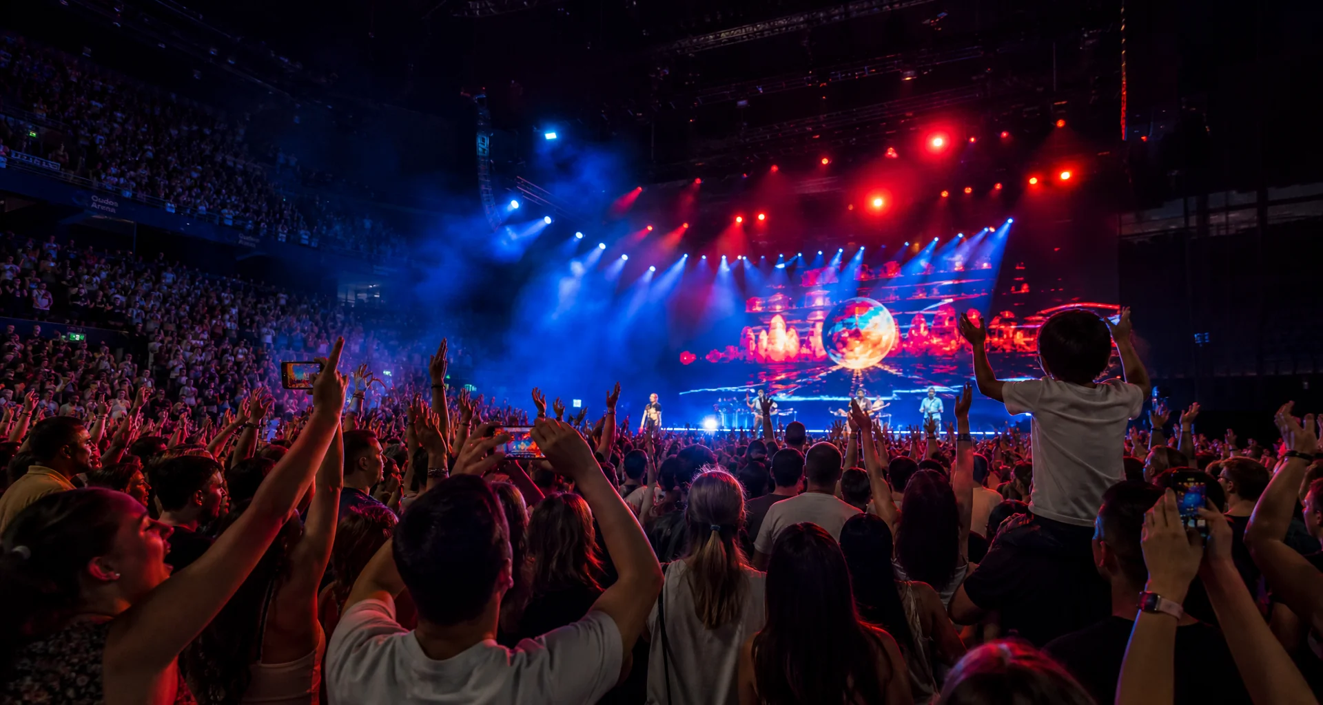 Concert arena crowd silhouette with illuminated stage glow